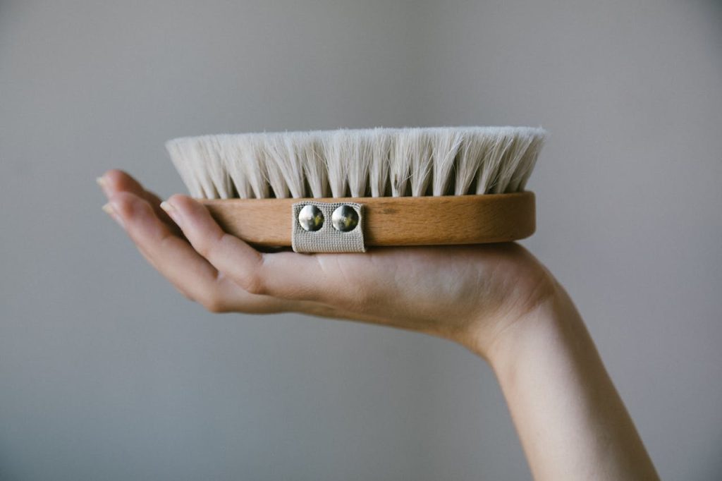 Close-Up Shot of a Person Holding a Shoe Brush